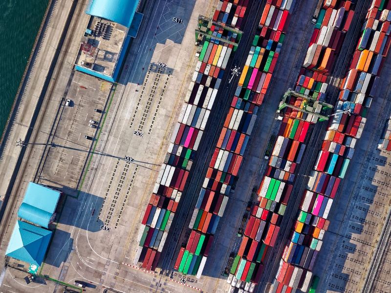 Aerial view of a container terminal and quay cranes at a bulk and logistics port