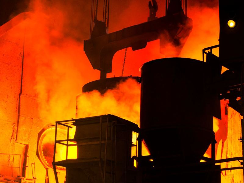 Ladle of molten metal being handled inside a steel mill
